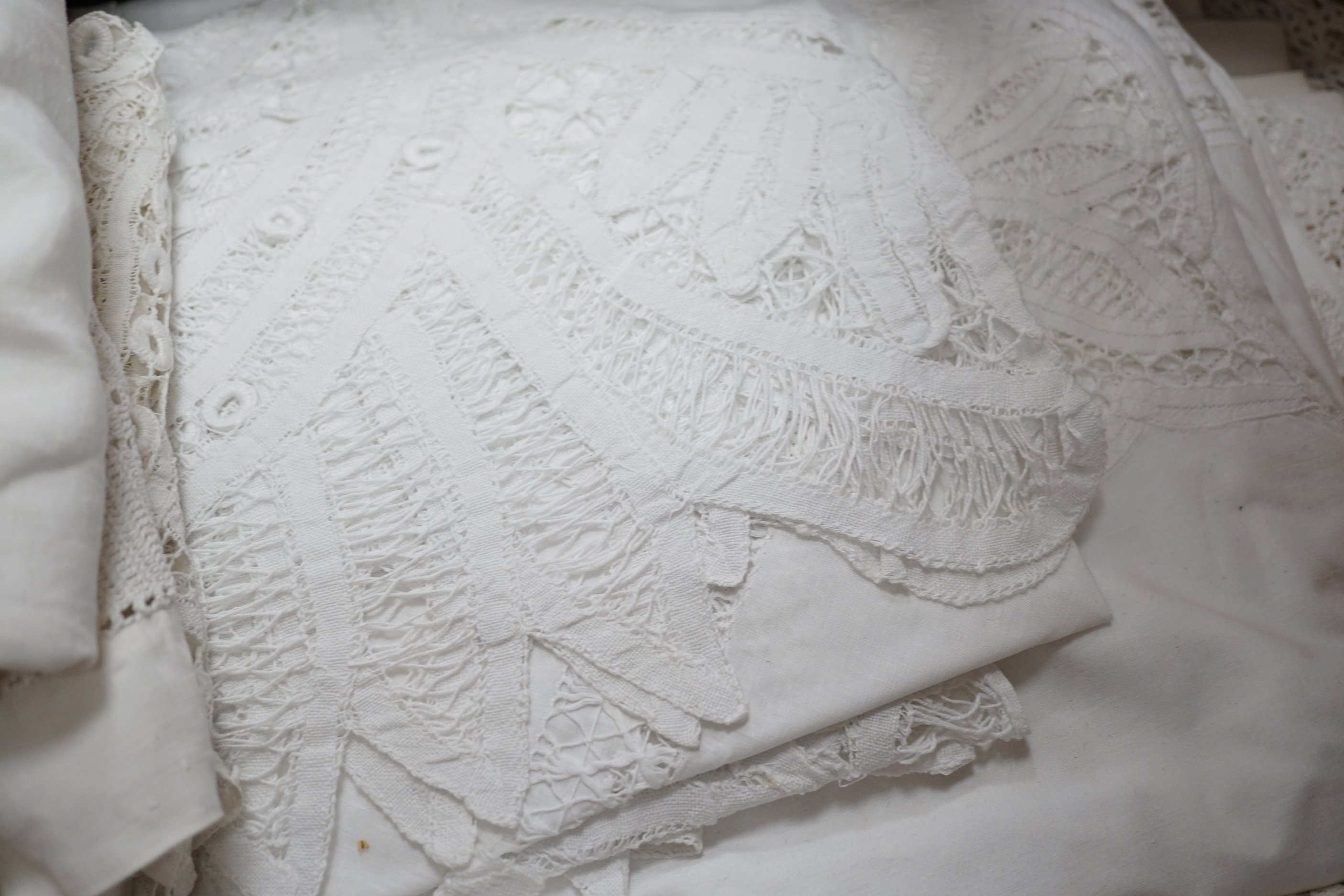 A collection of linen crochet and tape lace edged table cloths